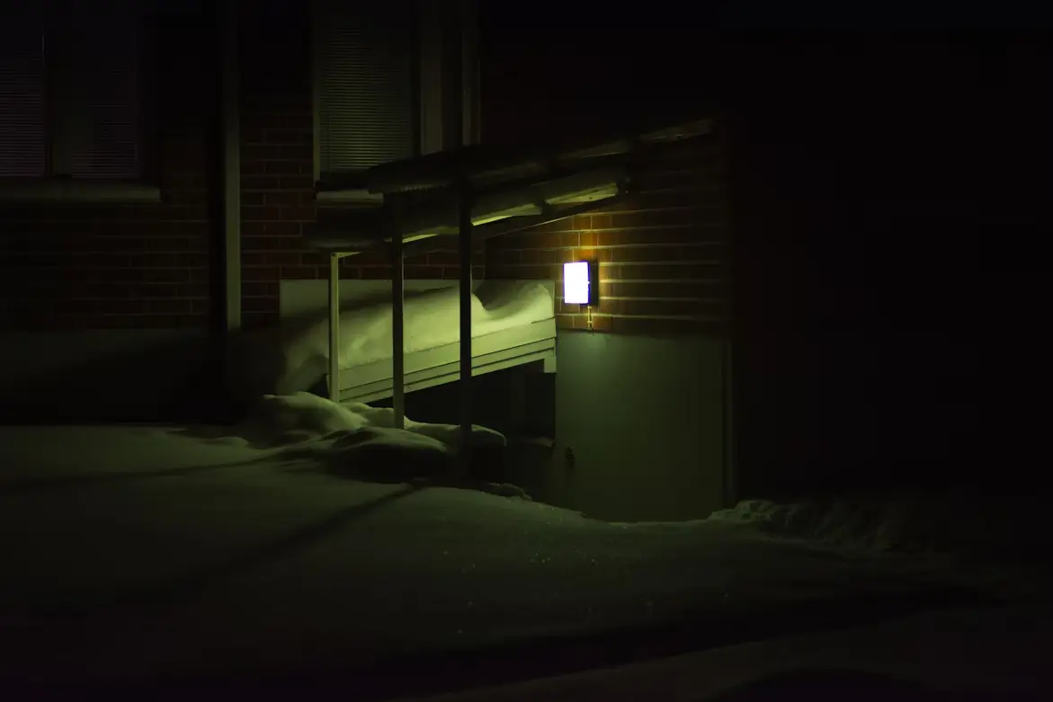 A basement entrance surrounded by snow.